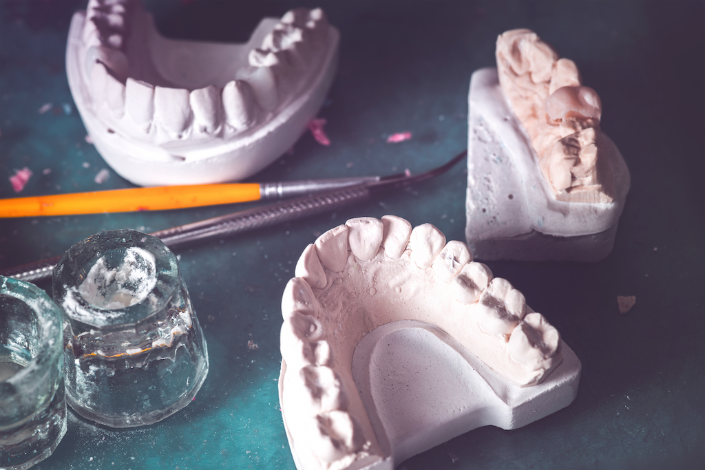 Dental prosthesis, artificial tooth. Photo of artificial teeth made in the dental laboratory.